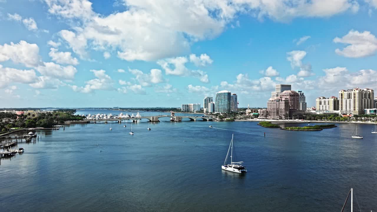 Aerial: Royal Park Bridge with One Flagler and Phillips Point building in West Palm Beach, Florida, USA, establishing drone shot