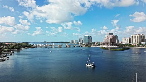 aerial: royal park bridge with one flagler and phillips point building in west palm beach, florida, usa, establishing drone shot