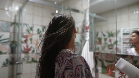 woman drying hair in the bathroom