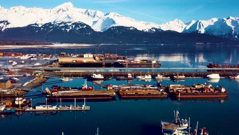 4K-Drone-Video-of-Seward-Boat-Harbor-and-Surrounding-Snow-Covered-Mountains-on-Snowy-Winter-Day-in-Alaska