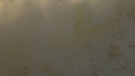 Big-wave-breaking-in-Nazare-beach-with-spray-making-a-haze-in-background