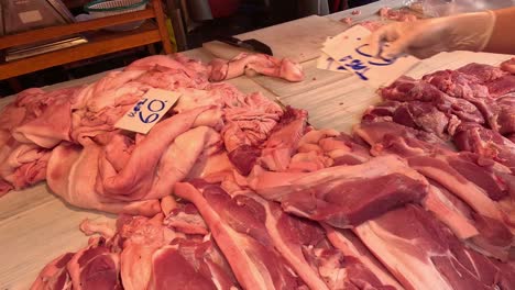 arranging and cutting various meats on a table