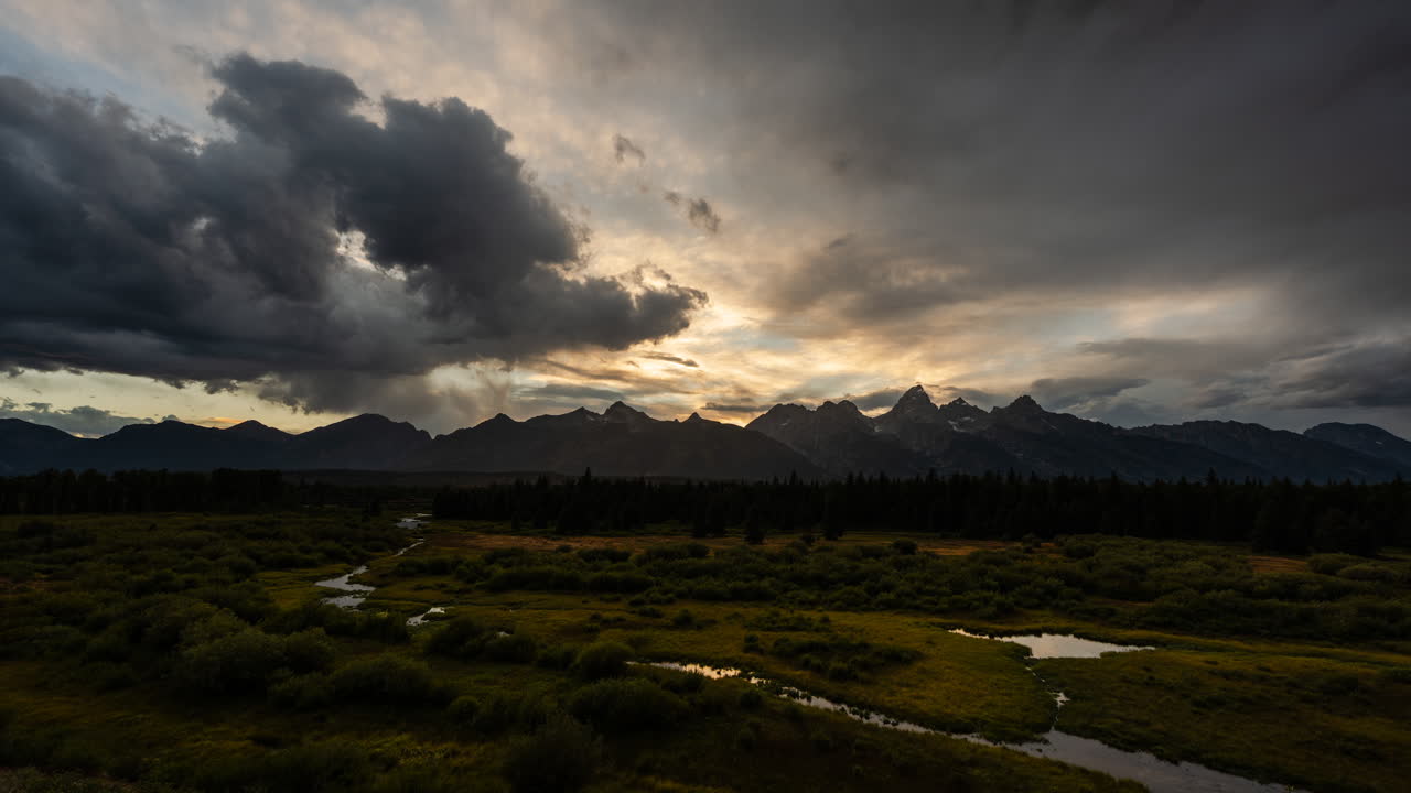 Dramatic Sunset Over Grand Teton Mountains and Wetlands