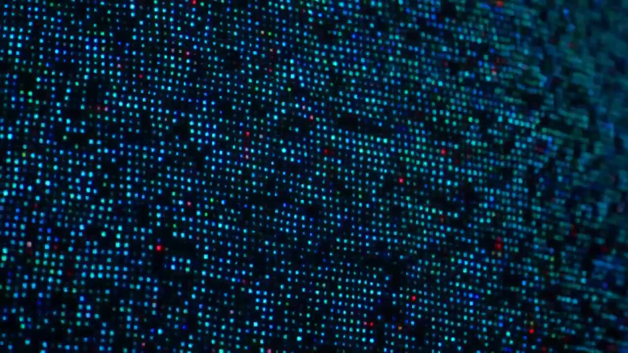 Close view of glowing blue and cyan pixels forming a dense abstract pattern across a dark curved surface, with soft blur, high contrast, and concentrated