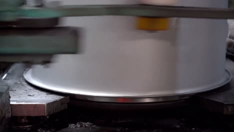 An-automated-machining-process-shapes-the-underside-of-the-drum-lid