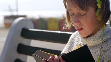 girl reading a book at beach 4k