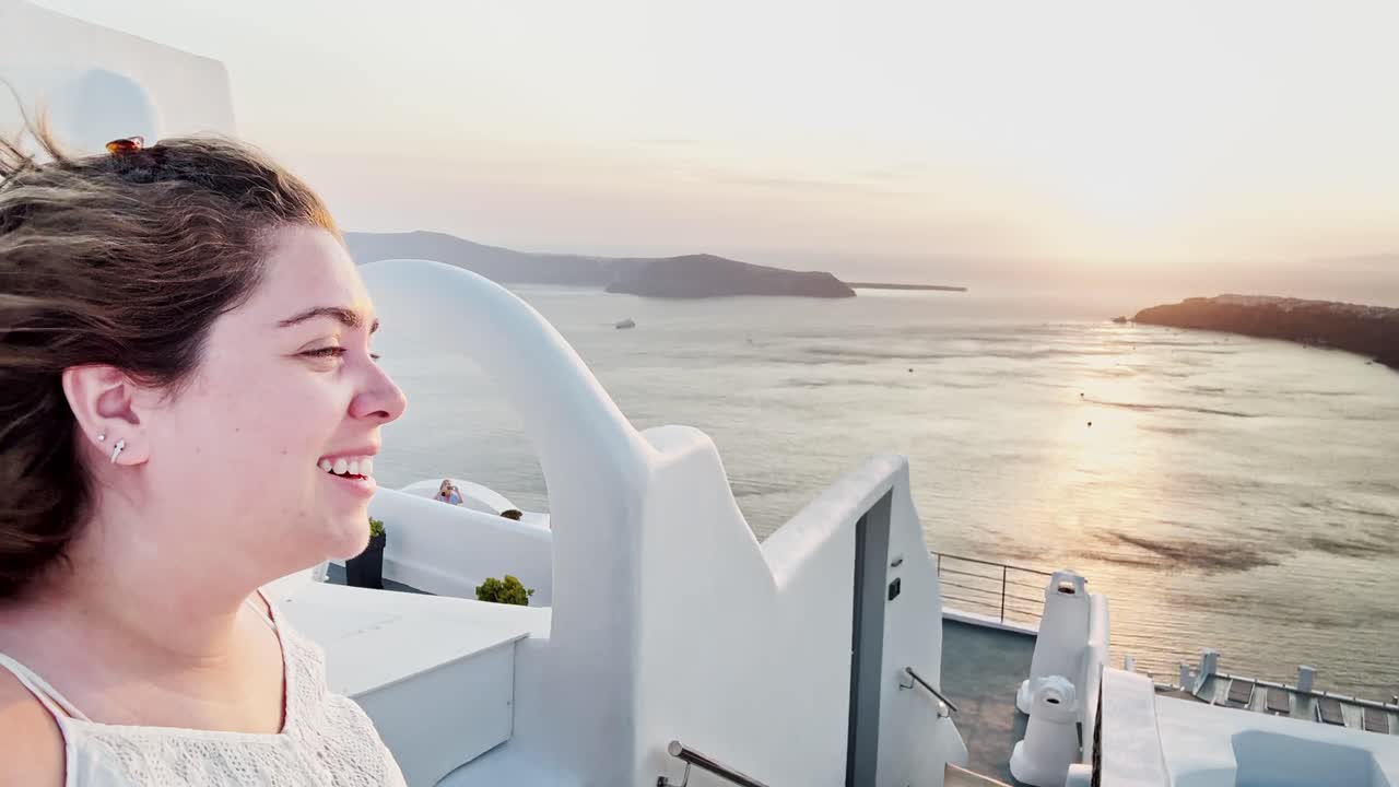 Woman Embracing Santorini Sunset View from Rooftop