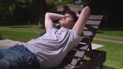 a boy relaxing outdoors in the sunshine - close up