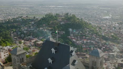 Fly-over-the-Malagasy-flag-on-Rova---kings-palace-on-the-hill-in-Antananarivo---capital-of-Madagscar
