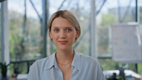 portrait young businesswoman posing at office interior. lady looking at camera