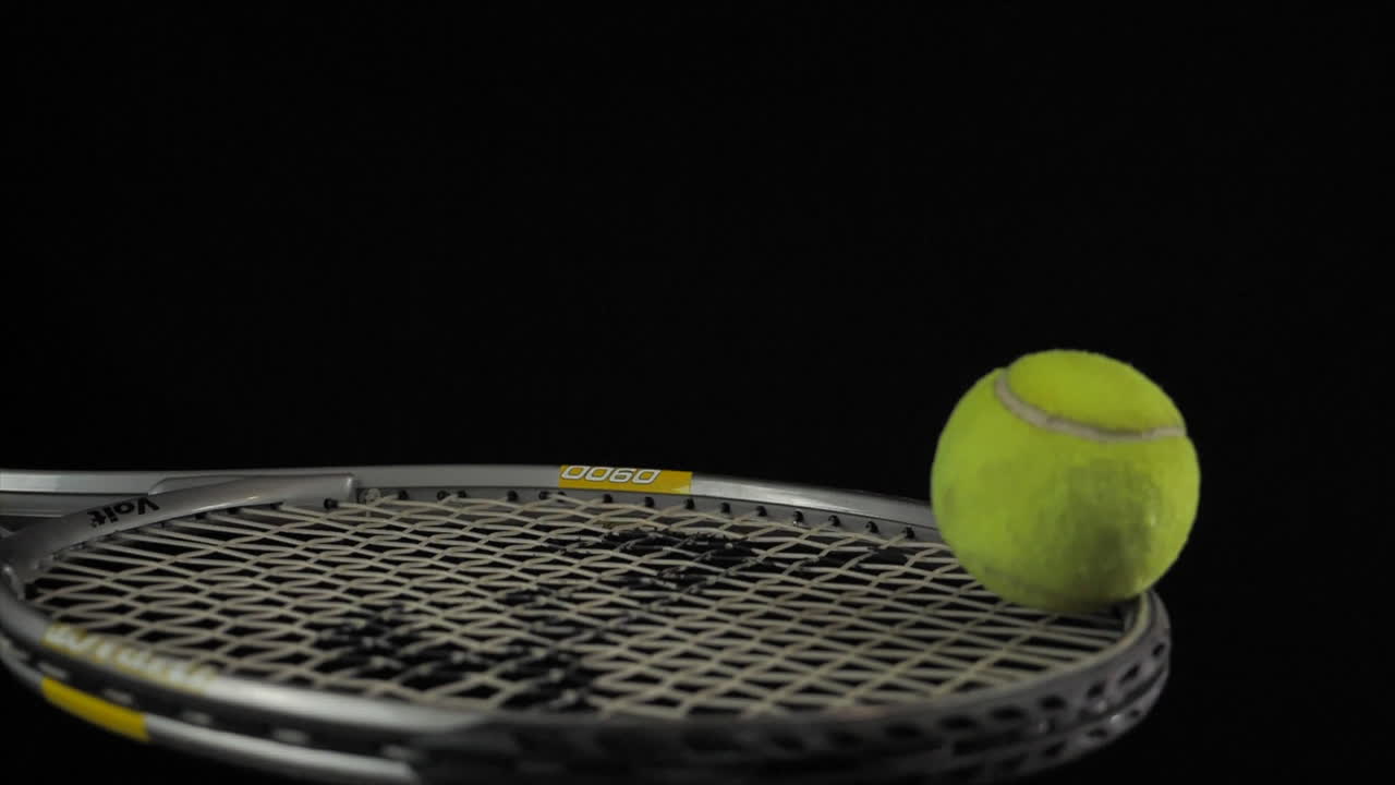 Tennis Ball bounces once on Tennis Racket in Slow Motion