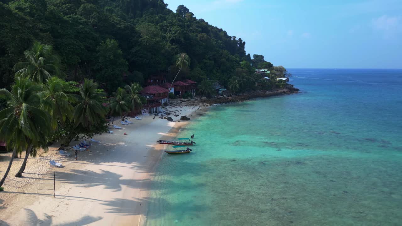 boats on Empty beach with palm tree shadow in the morning