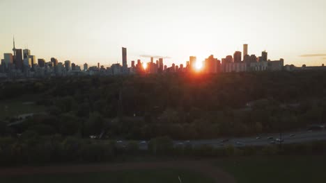 aerial drone shot of toronto city at sunset while camera rises