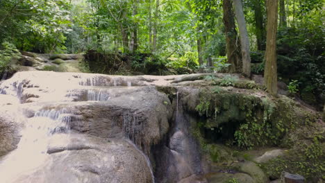tranquil waterfall in a lush forest setting near kanchanaburi