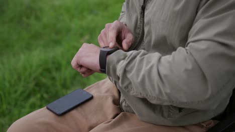 man in a wheelchair looking at his watch