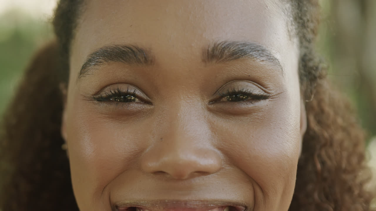 Portrait of happy african american woman hiking in forest, slow motion