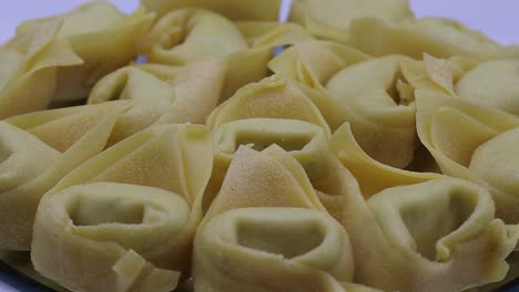 fresh tortelloni with ricotta and parsley on a turntable