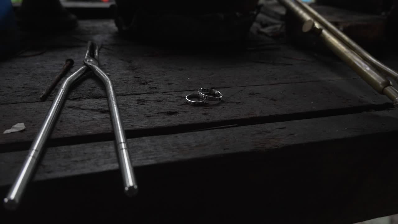 SIlver engagement rings crafting jewelry on hardwood table top workshop studio