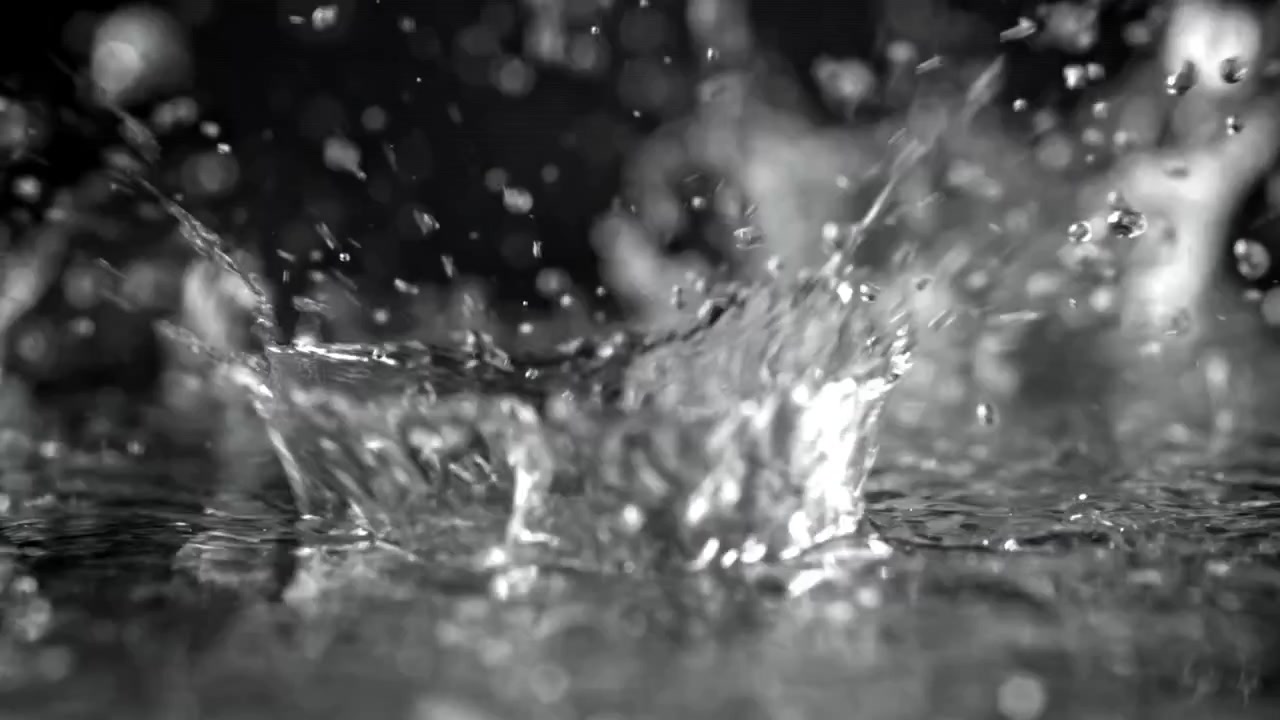 Water Droplets Falling and Splashing in Slow Motion on Dark Background