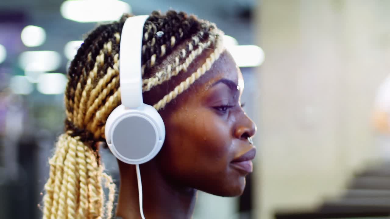 mujer en forma con teléfono inteligente haciendo ejercicio en bicicleta de ejercicio