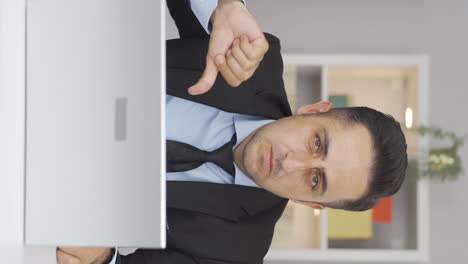 Vertical-video-of-Home-office-worker-man-making-negative-gesture-at-camera.