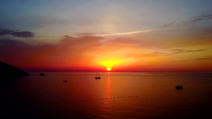 Beautiful view of sunrise, calm sea nature scene on summer morning. Drone flight