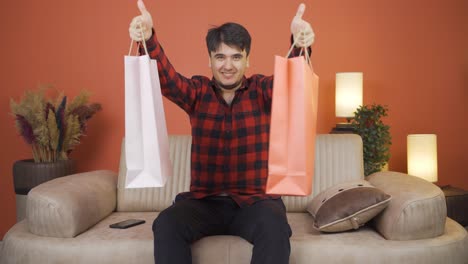 man looking at camera with shopping bags.