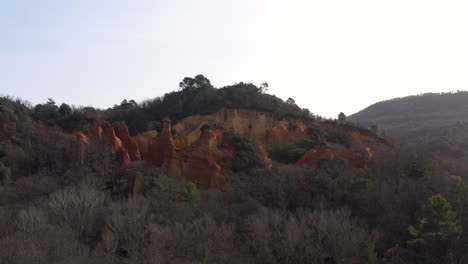 Red-ochre-mountain-old-quarry-in-an-forest-aerial-shot-Colorado-Provencal