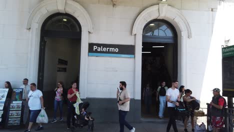 establishing shot of palermo train station cityscape of buenos aires downtown with evangelic religious preachers and pedestrians, sellers and commuters