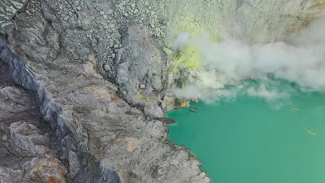 dramatic aerial view of a crater acid lake kawah ijen where sulfur is mined