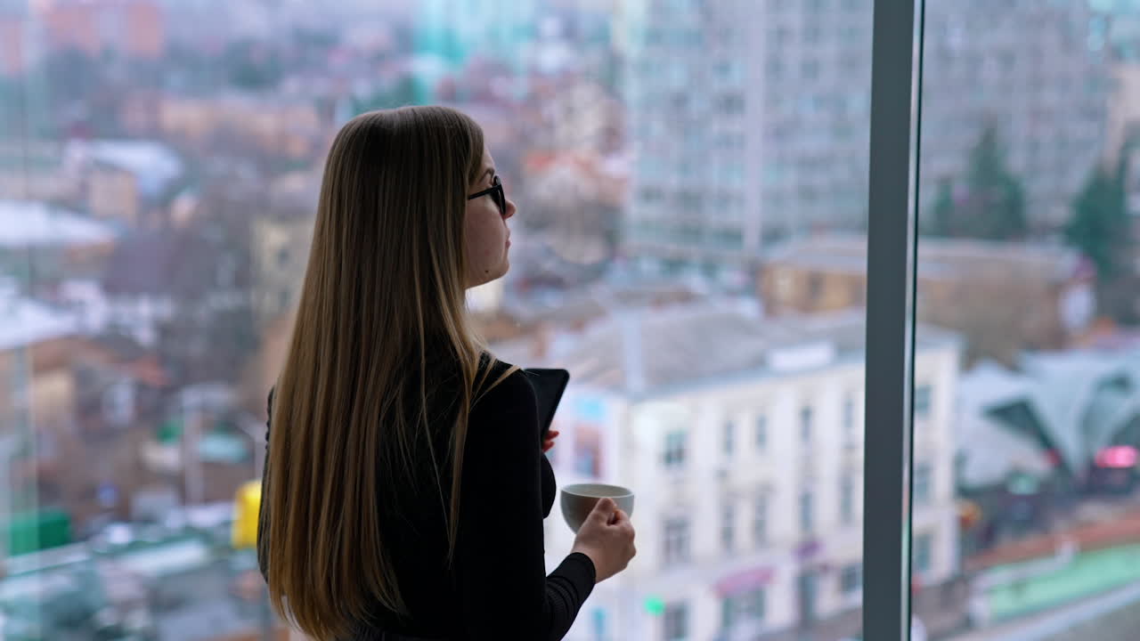 Beautiful woman wearing eyeglasses using cellphone and drinking coffee