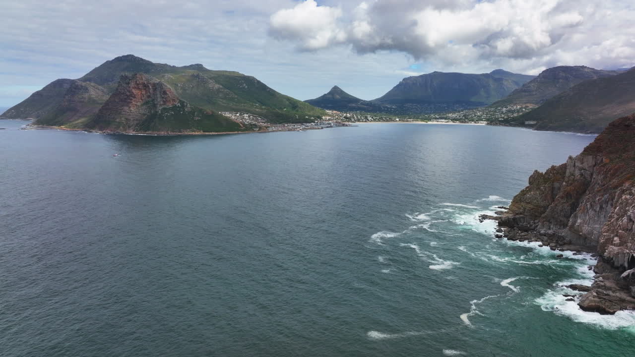 Chapman Peak South Africa aerial cinematic drone Hout Bay marina Cape Town Fish Hoek Good Hope Simon's Town waves crashing rugged coast stunning aqua deep blue water lush green spring summer forward