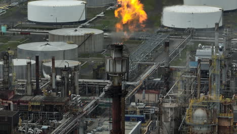 ascending aerial of flame exhaust at oil refinery