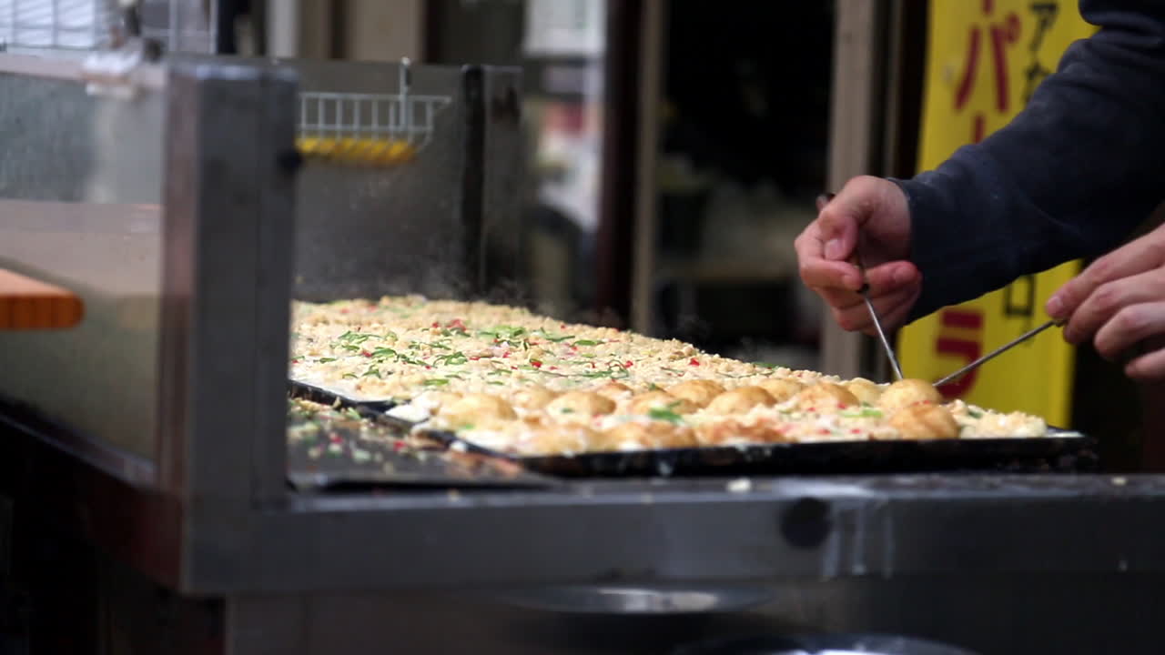 Close-up: Preparing street food in Japan using chopsticks