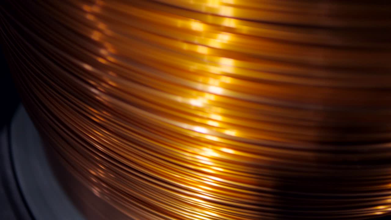 Close-up of the rotation of the coil and wrap it copper wire. Manufacture of electric cable.