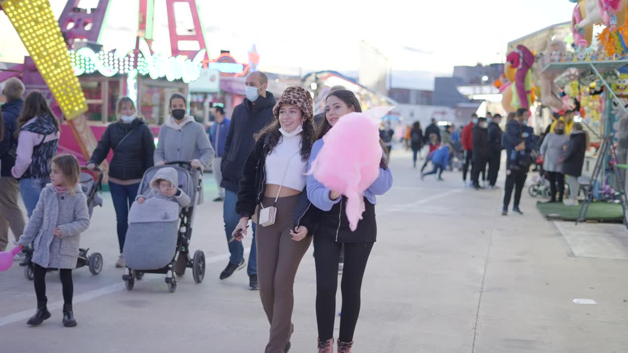 Girls enjoying cotton candy at a fair