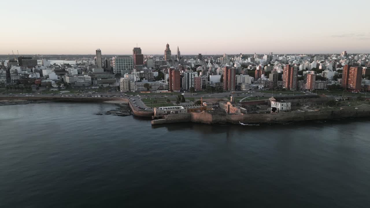 Aerial view approaching Montevideo Play del Gas skyscraper cityscape skyline near Gran Breta&ntilde;a coastal highway road