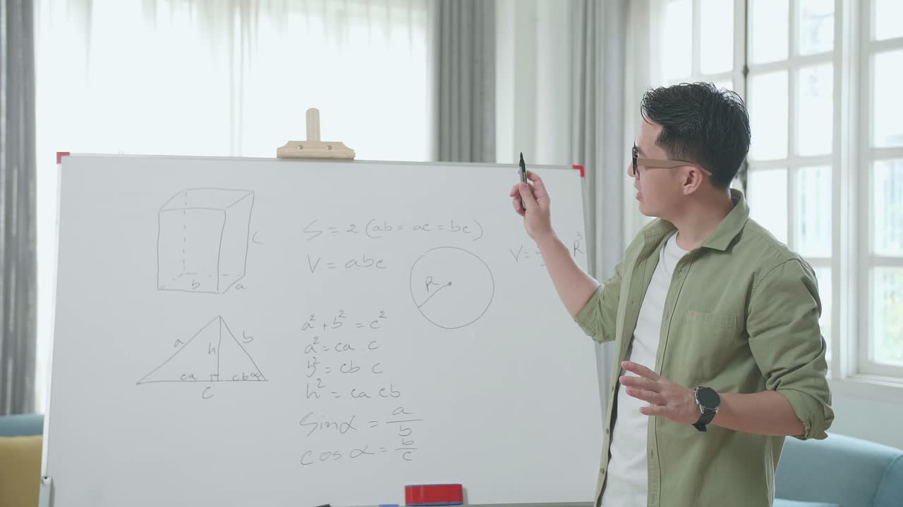 Asian Male Teacher With Glasses Teaching Math At Home
