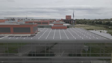 modern office with solar power - solar panels on top of smart office unit in park west business park, dublin, ireland - drone shot