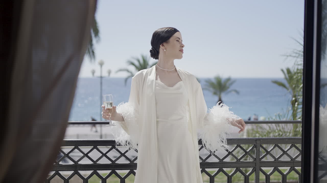 Woman enjoying Champagne on a Balcony with Sea View