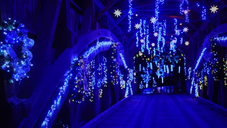 a view of a christmas display of the interior of a covered bridge