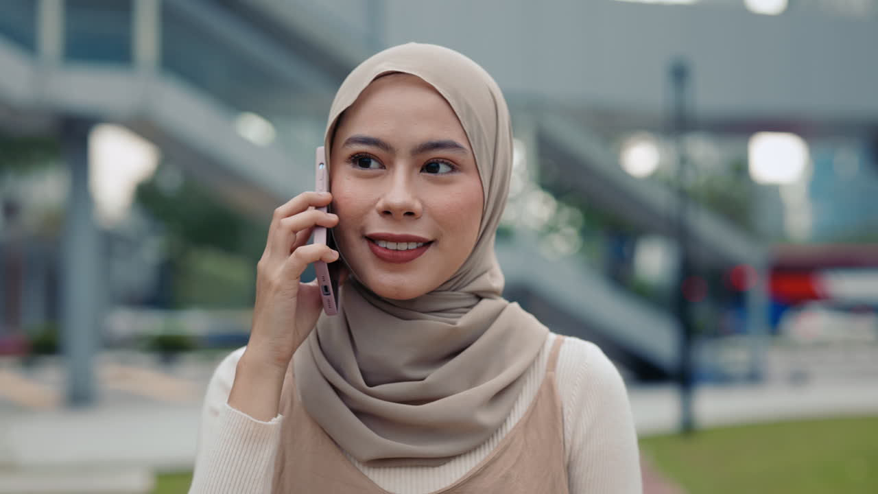 Woman in hijab using mobile phone