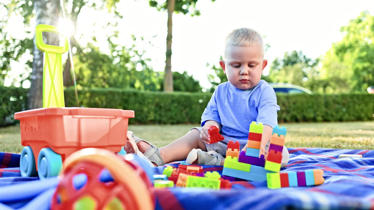 Creative Playtime Engaging and Interactive Toddler Building Activities with Colorful Blocks on a Bright and Sunny Day in the Great Outdoors, Encouraging Exploration and Learning for Young Minds