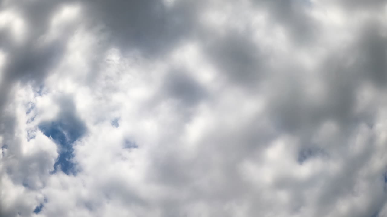 Swirling clouds in timelapse. A mesmerizing timelapse captures clouds shifting and swirling overhead, showcasing nature's ever-changing sky