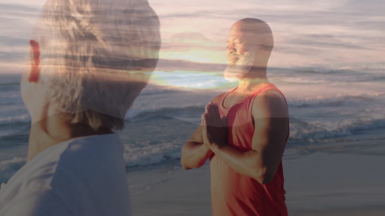 Mature man and senior woman practicing beach yoga under pastel sunrise, with floating health icons