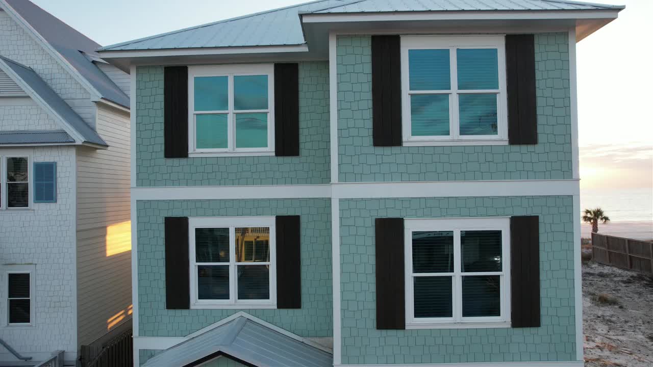Drone Ascending Outside A Beach House Revealing Seascape And Beach At Sunset In Panama City Beach, Florida. aerial