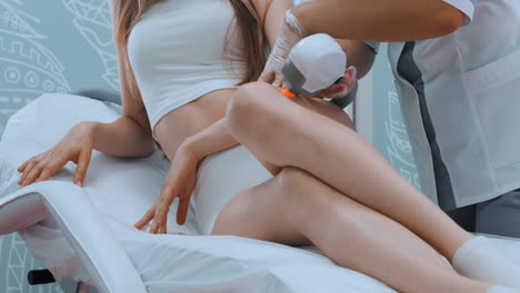 Laser-hair-removal-procedure-in-beauty-clinic-close-up-woman-legs-during-epilation-slow-motion.-Concept-of-women-beauty-cosmetology