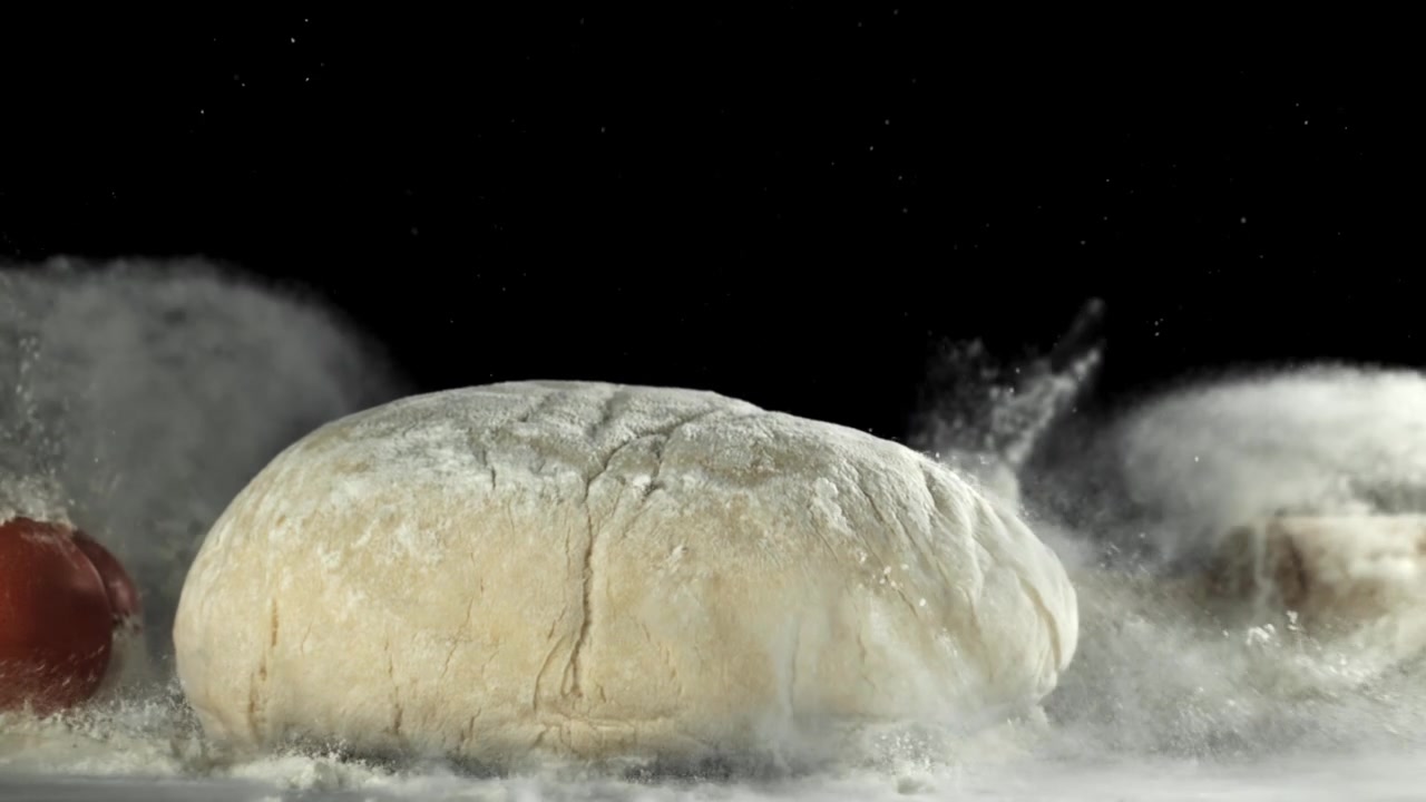 Slow Motion of Fresh Dough Falling onto Flour with Ingredients