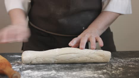 making meat dumpling with wooden rolling pin.