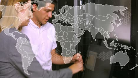 animation of world map over diverse it people using laptop